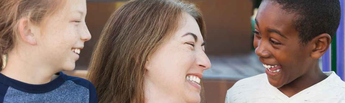 Image of girl, woman and boy all smiling